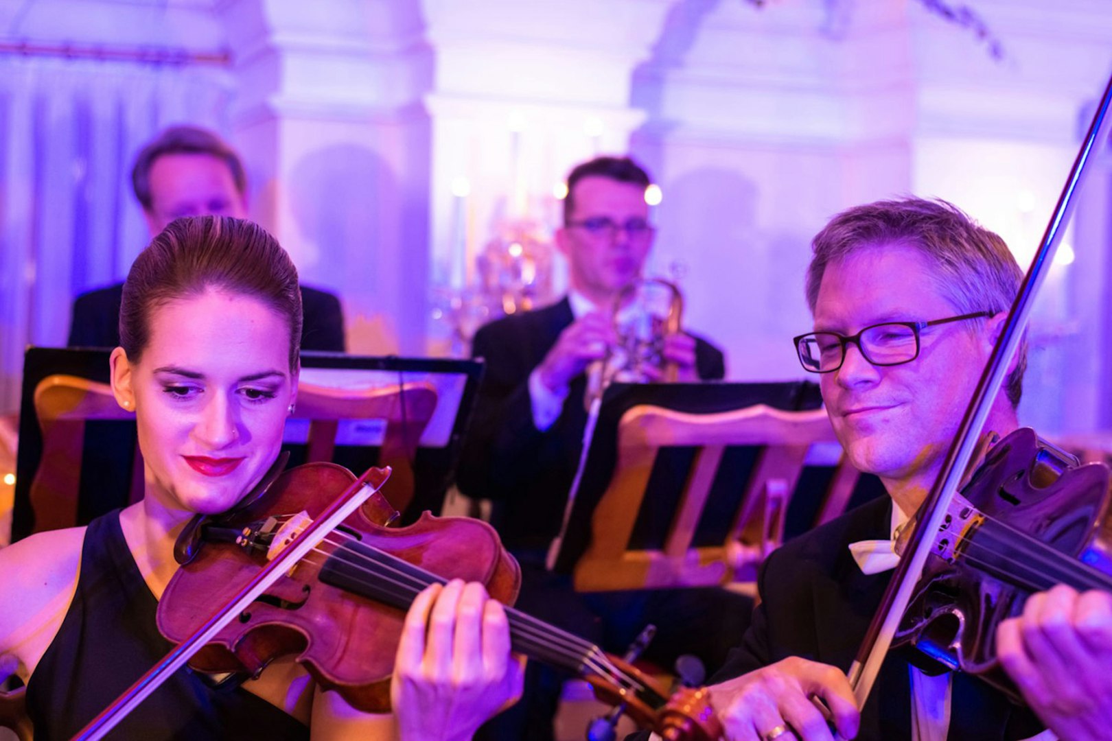 Musicians playing violins at Mozart and Strauss concert in Kursalon Vienna.