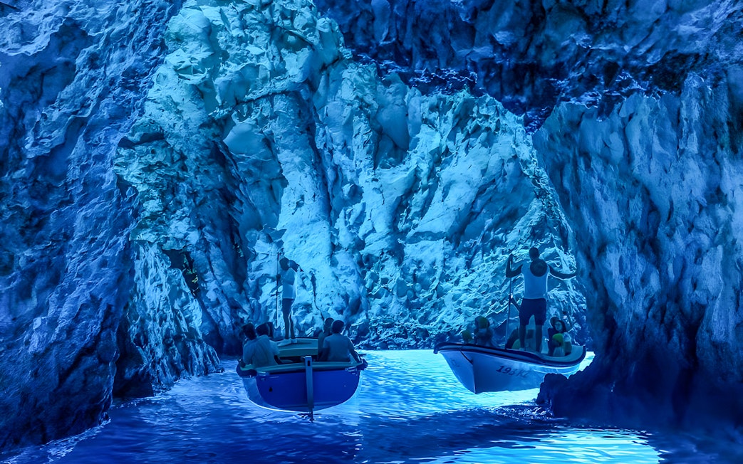 Tourists in small boats explore the Blue Cave near Split.