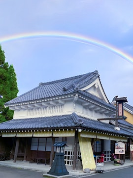 Traditional Japanese building with a rainbow at Noboribetsu Jidaimura, Japan.
