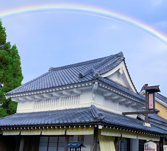 Traditional Japanese building with a rainbow at Noboribetsu Jidaimura, Japan.
