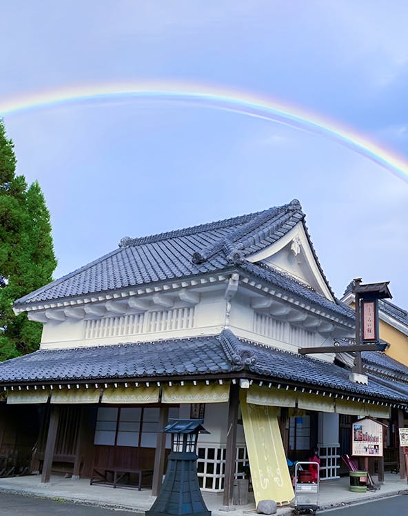 Traditional Japanese building with a rainbow at Noboribetsu Jidaimura, Japan.