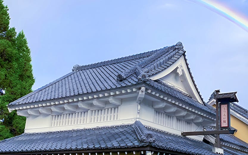 Traditional Japanese building with a rainbow at Noboribetsu Jidaimura, Japan.