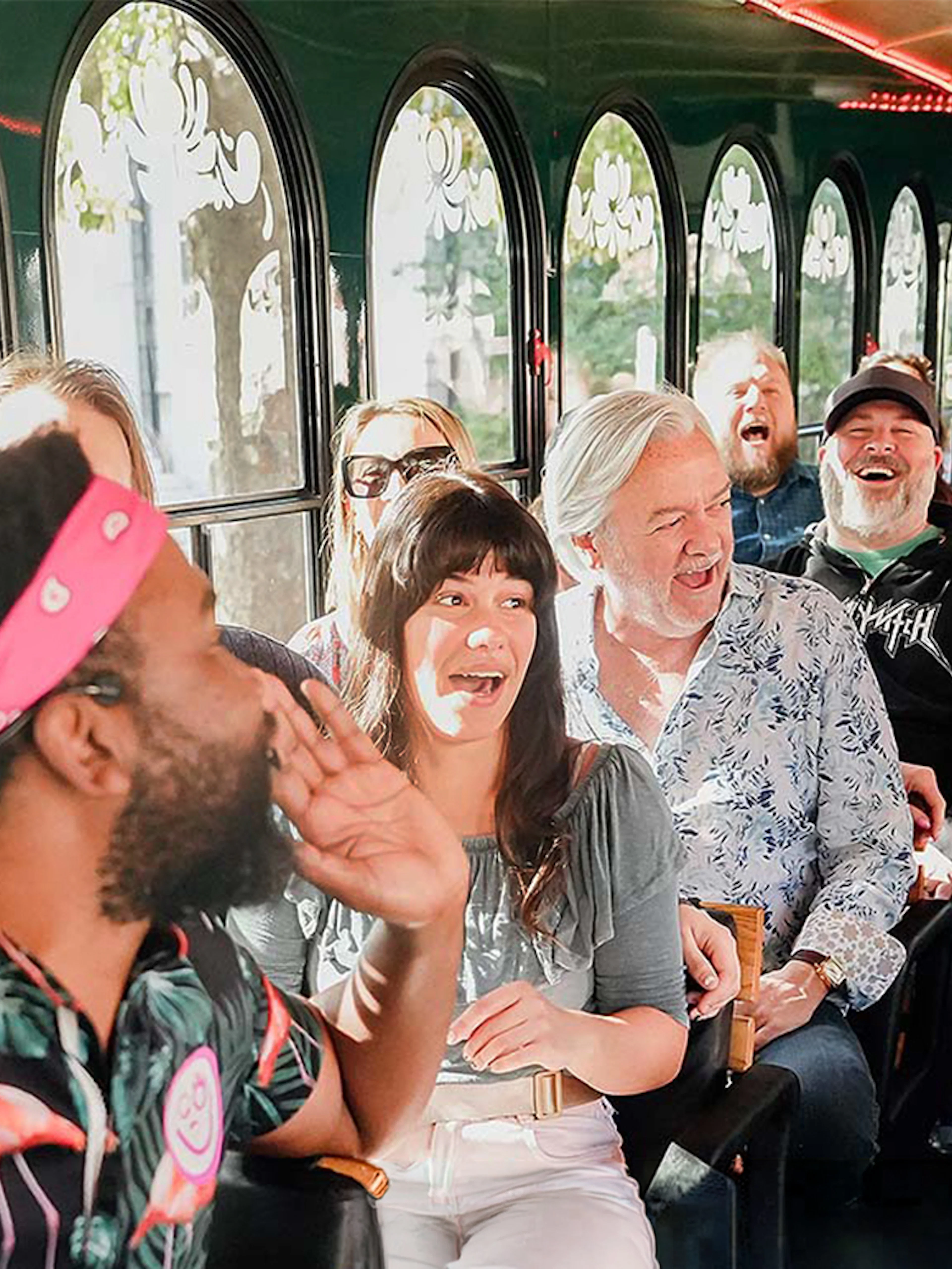 Group enjoying Savannah for Morons Trolley Tour with guide entertaining passengers.