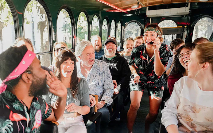 Group enjoying Savannah for Morons Trolley Tour with guide entertaining passengers.