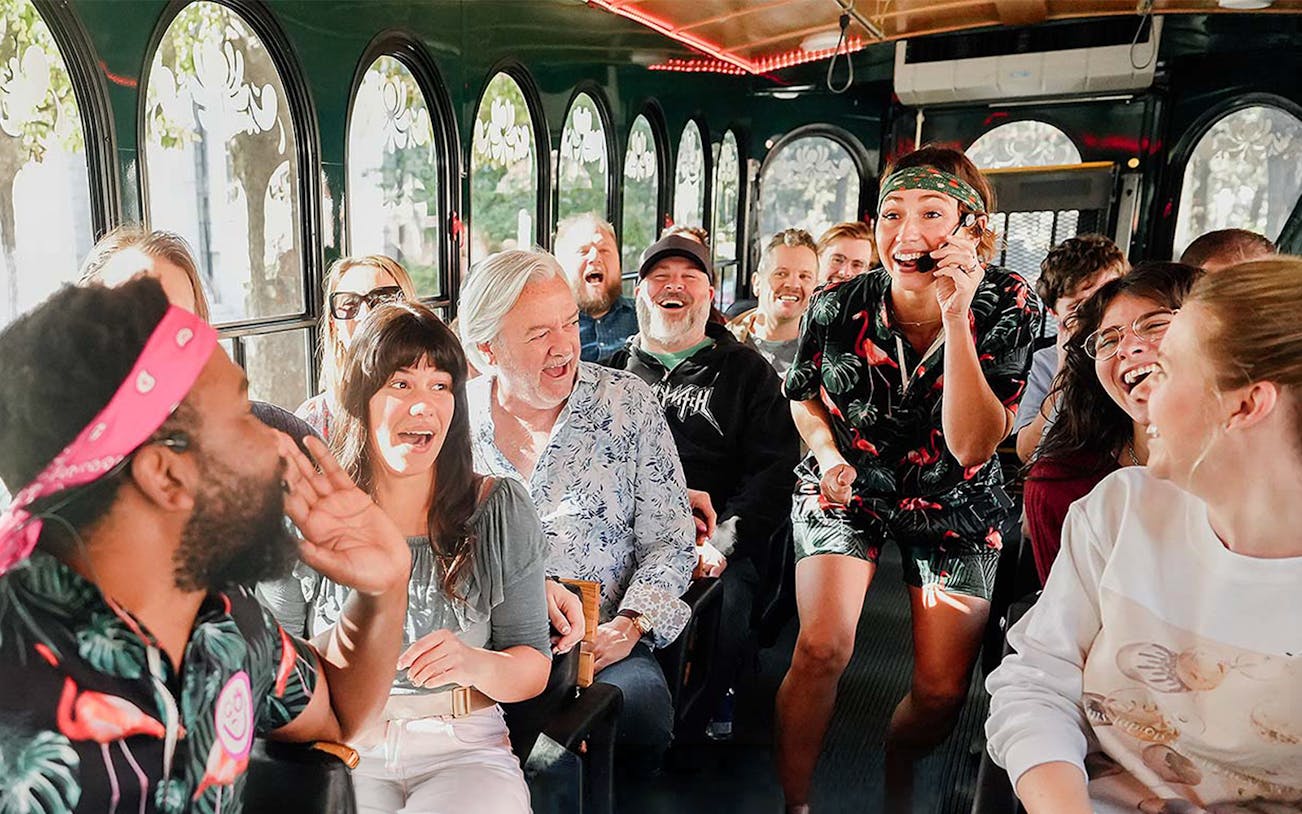 Group enjoying Savannah for Morons Trolley Tour with guide entertaining passengers.
