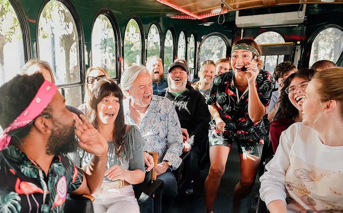 Group enjoying Savannah for Morons Trolley Tour with guide entertaining passengers.