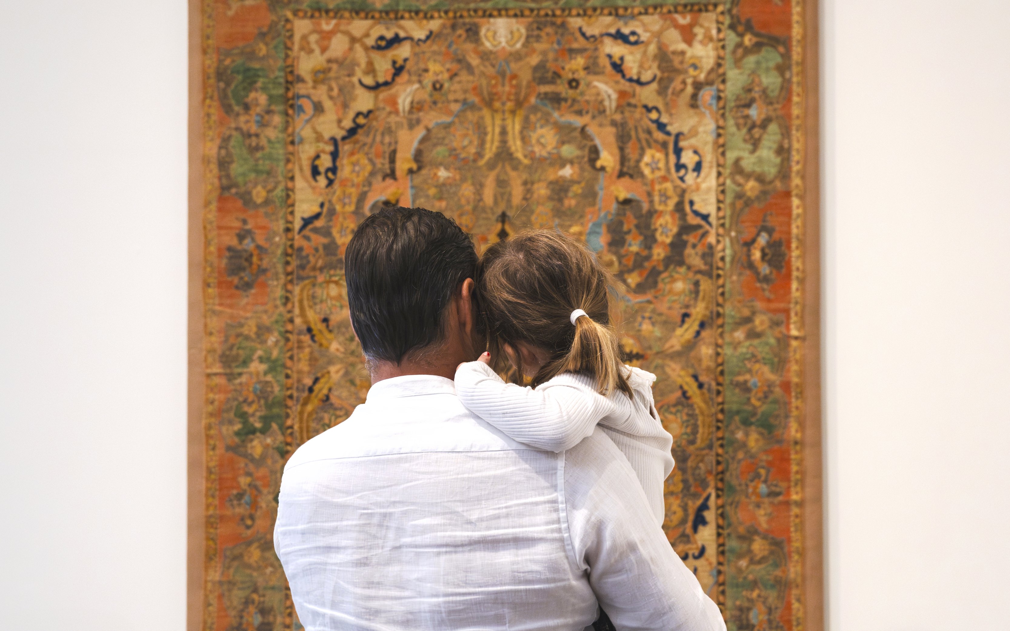 Family viewing tapestry at Louvre Abu Dhabi.
