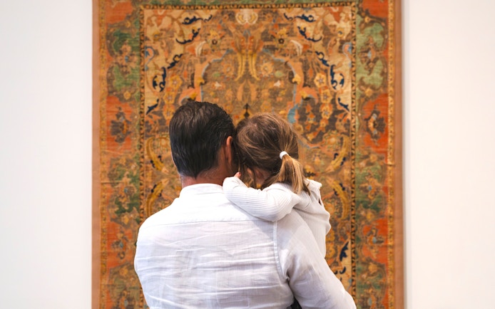 Family viewing tapestry at Louvre Abu Dhabi.