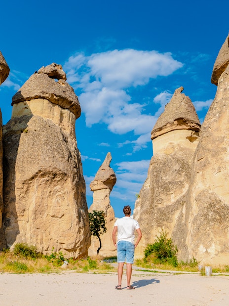 Person standing among fairy chimneys in Pasabag Monks Valley, Cappadocia.