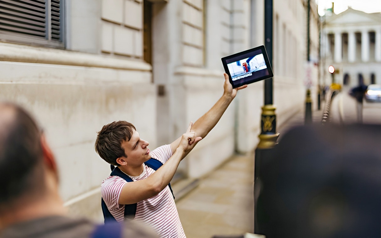 Guide showing Harry Potter film location on tablet during walking tour.
