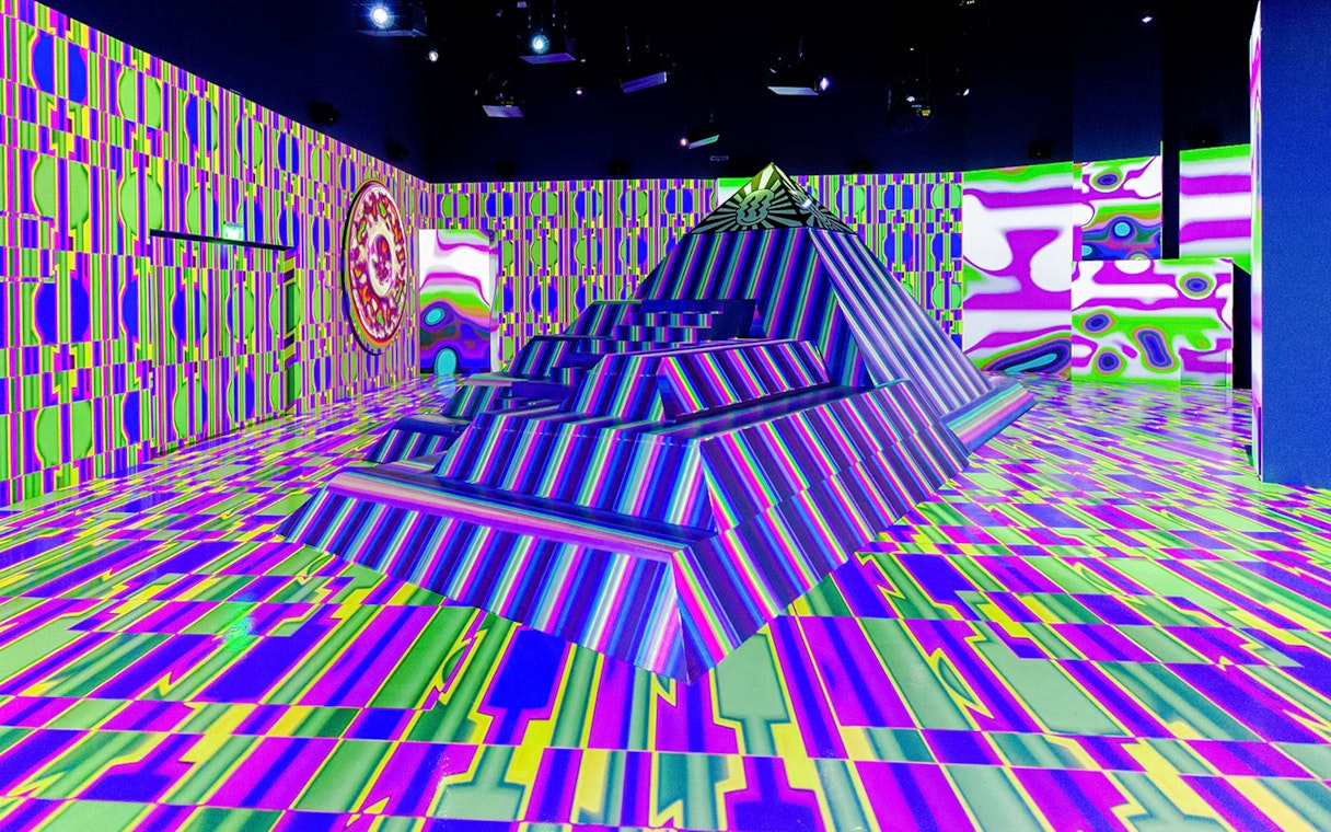 Colorful geometric installation at House of Hype with vibrant patterns and pyramid structure.