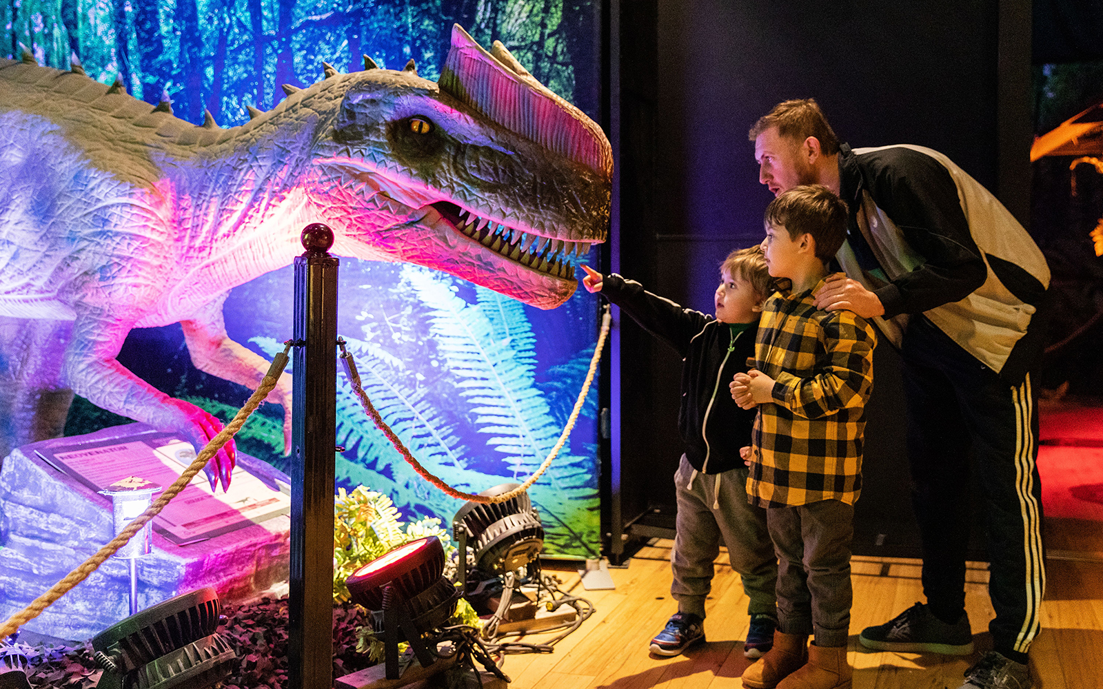 Family exploring dinosaur exhibit at Las Vegas attraction.