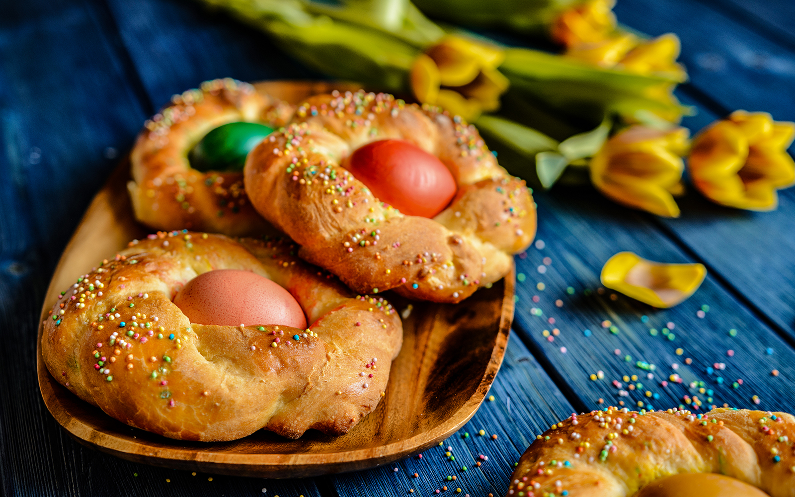 Traditional Italian Easter bread rings with eggs and colorful sprinkles.