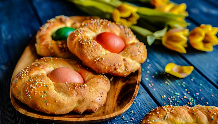 Traditional Italian Easter bread rings with eggs and colorful sprinkles.