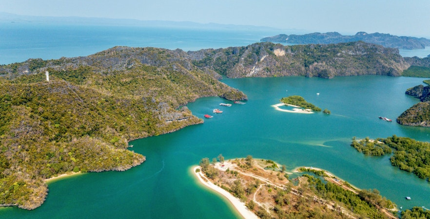 Aerial view of Kilim Geoforest Park showcasing limestone formations and lush mangroves in Langkawi, Malaysia.