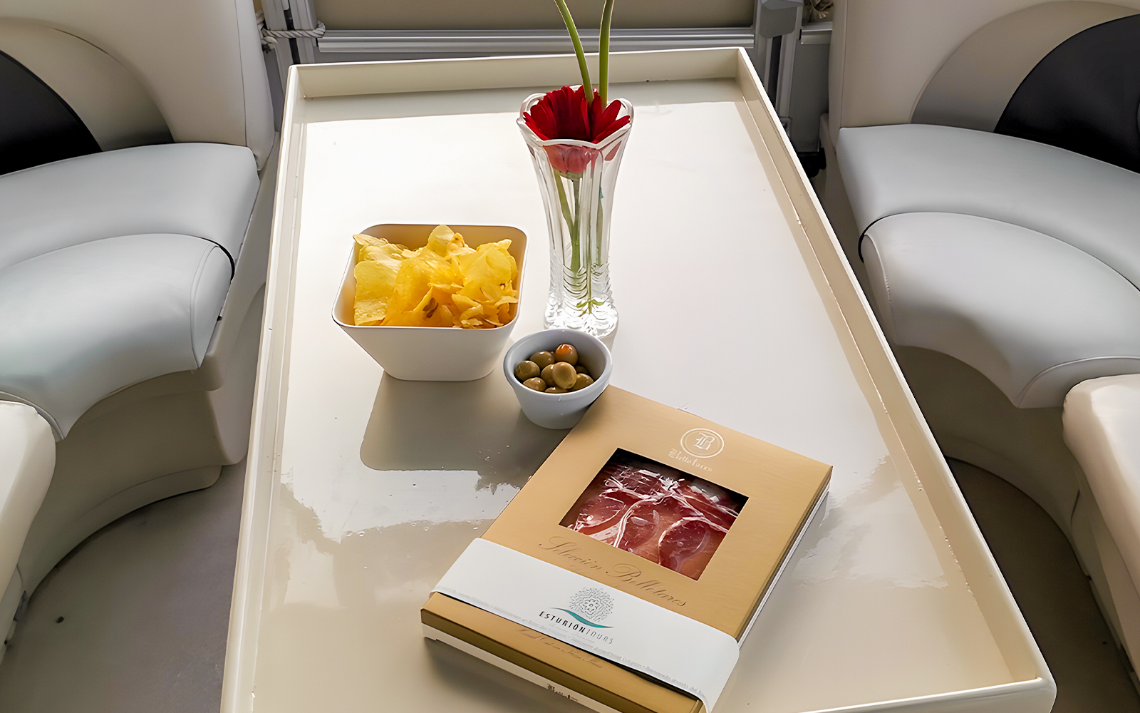 Tapas and drinks setup on a table during Guadalquivir River cruise.