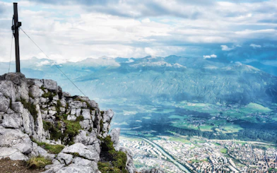 View from Nordkettenbahn summit overlooking Innsbruck and surrounding mountains.