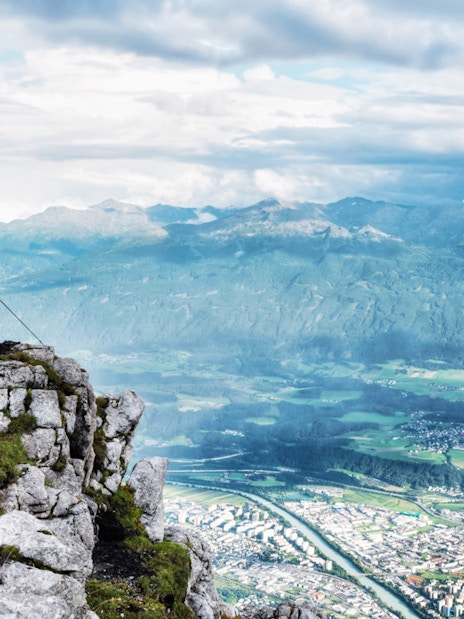 View from Nordkettenbahn summit overlooking Innsbruck and surrounding mountains.