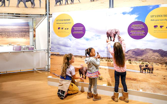 Children interacting with an elephant exhibit at the American Museum of Natural History.