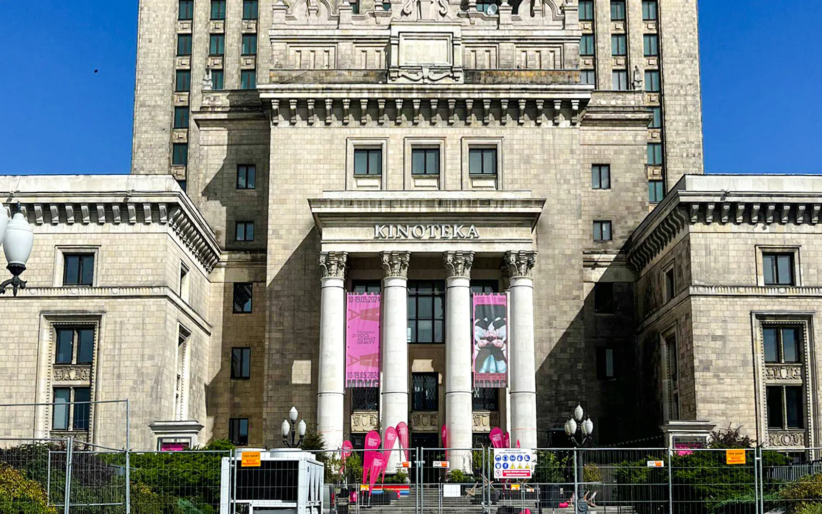 Palace of Culture and Science entrance with columns and banners, Warsaw.