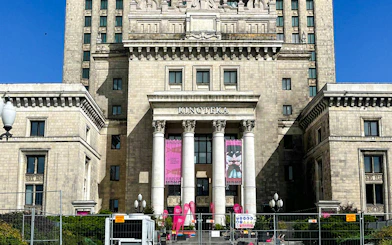 Palace of Culture and Science entrance with columns and banners, Warsaw.