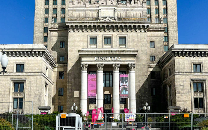 Palace of Culture and Science entrance with columns and banners, Warsaw.
