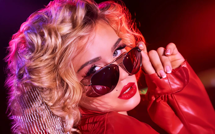Performer in red jacket and sunglasses from La Ronde cast, Sydney.