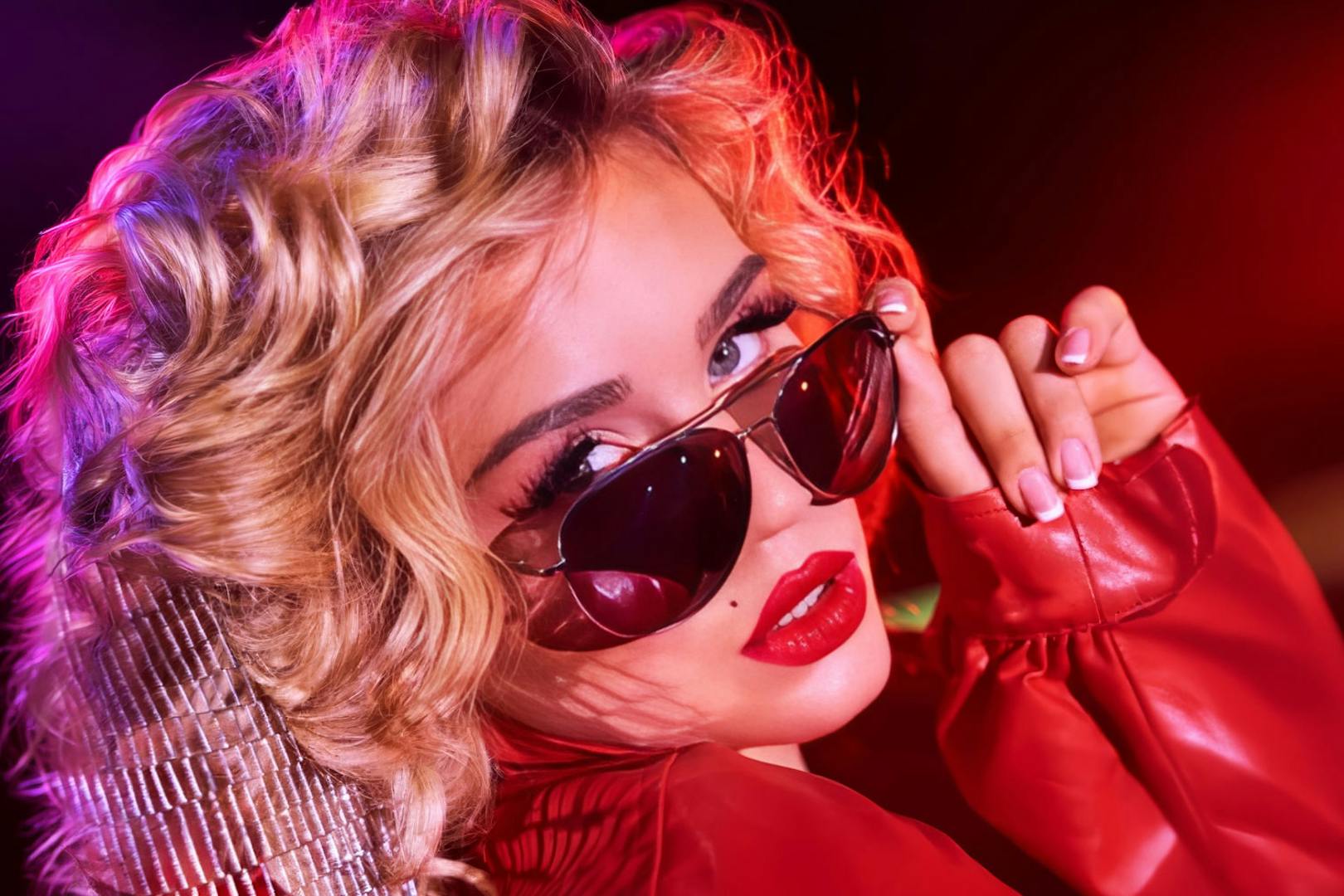 Performer in red jacket and sunglasses from La Ronde cast, Sydney.