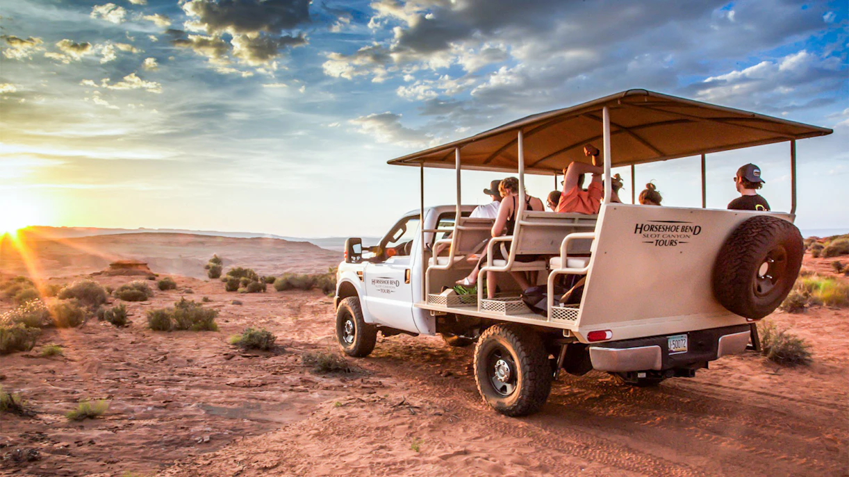 Tour group in open-air vehicle exploring Secret Antelope Canyon and Horseshoe Bend at sunset.
