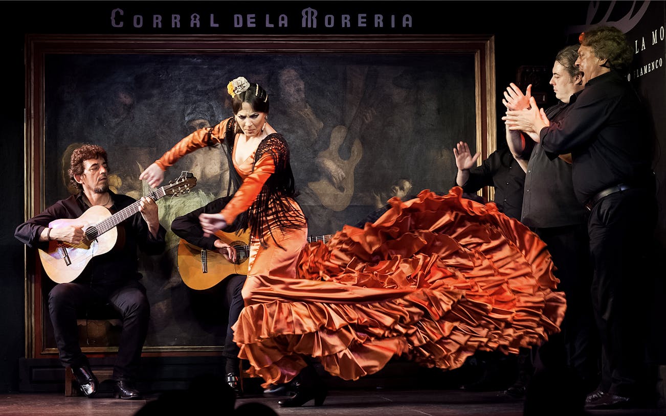 Flamenco dancer performing at Corral de la Morería with musicians in Madrid.