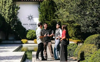 Tourists enjoying wine at Santa Carolina Winery in Santiago.