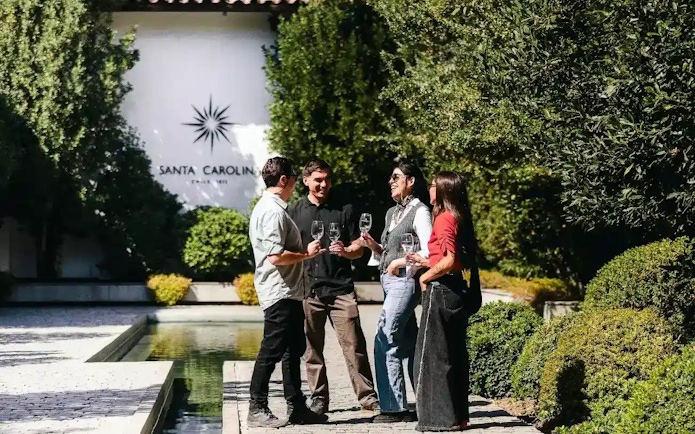 Tourists enjoying wine at Santa Carolina Winery in Santiago.