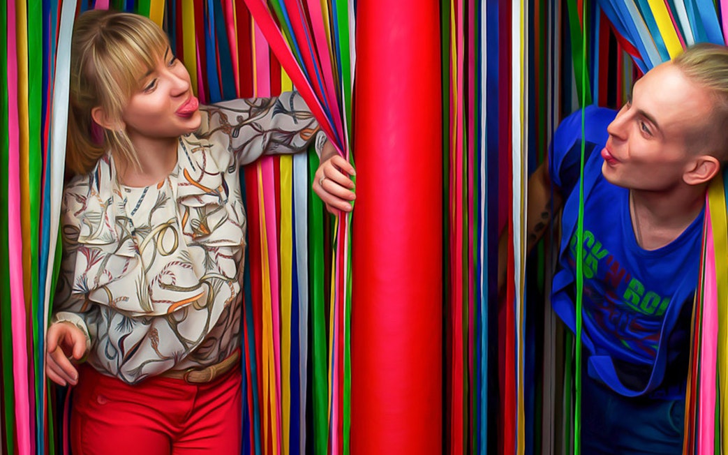 Visitors interacting with colorful ribbons at Big Fun Museum, Barcelona.