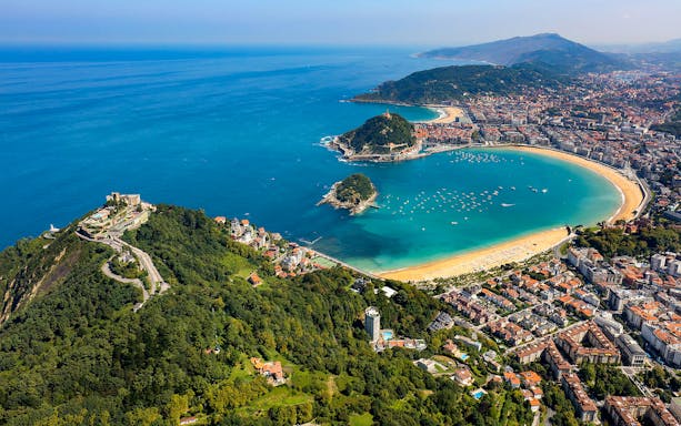 Aerial view of San Sebastian's La Concha Bay and coastline, part of the guided tour from Bilbao.