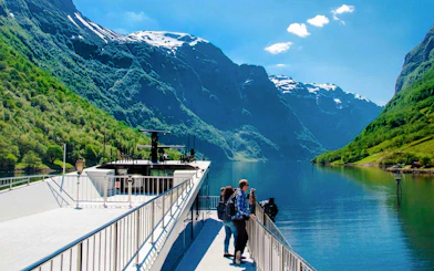 Cruise ship on Nærøyfjord with passengers enjoying views of mountains, Western Norway.
