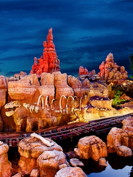 Frontierland's Big Thunder Mountain Railroad at Disneyland Park, California, with rocky landscape.