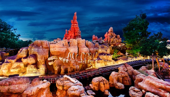 Frontierland's Big Thunder Mountain Railroad at Disneyland Park, California, with rocky landscape.