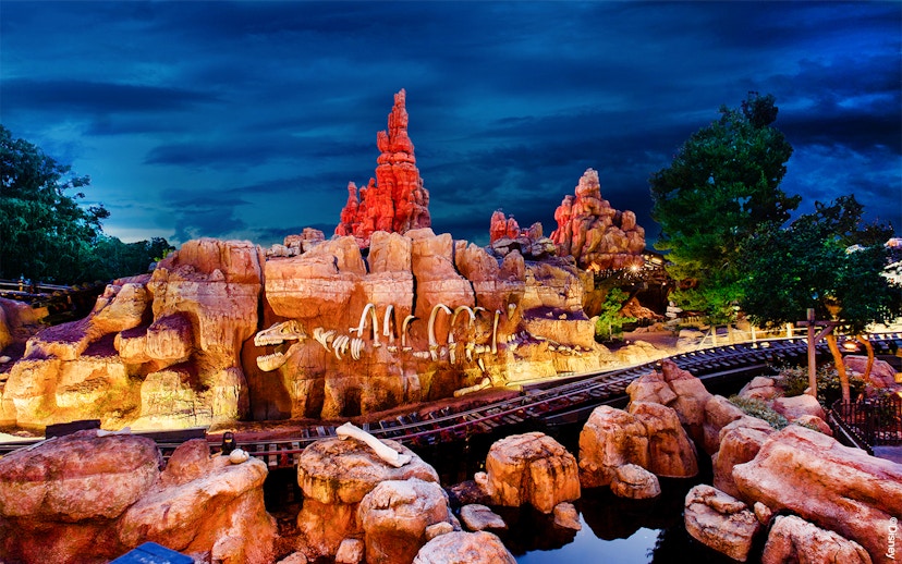 Frontierland's Big Thunder Mountain Railroad at Disneyland Park, California, with rocky landscape.