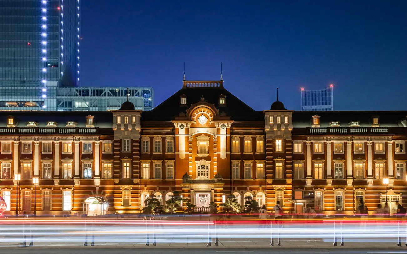 Tokyo Station illuminated at night, showcasing its historic architecture.