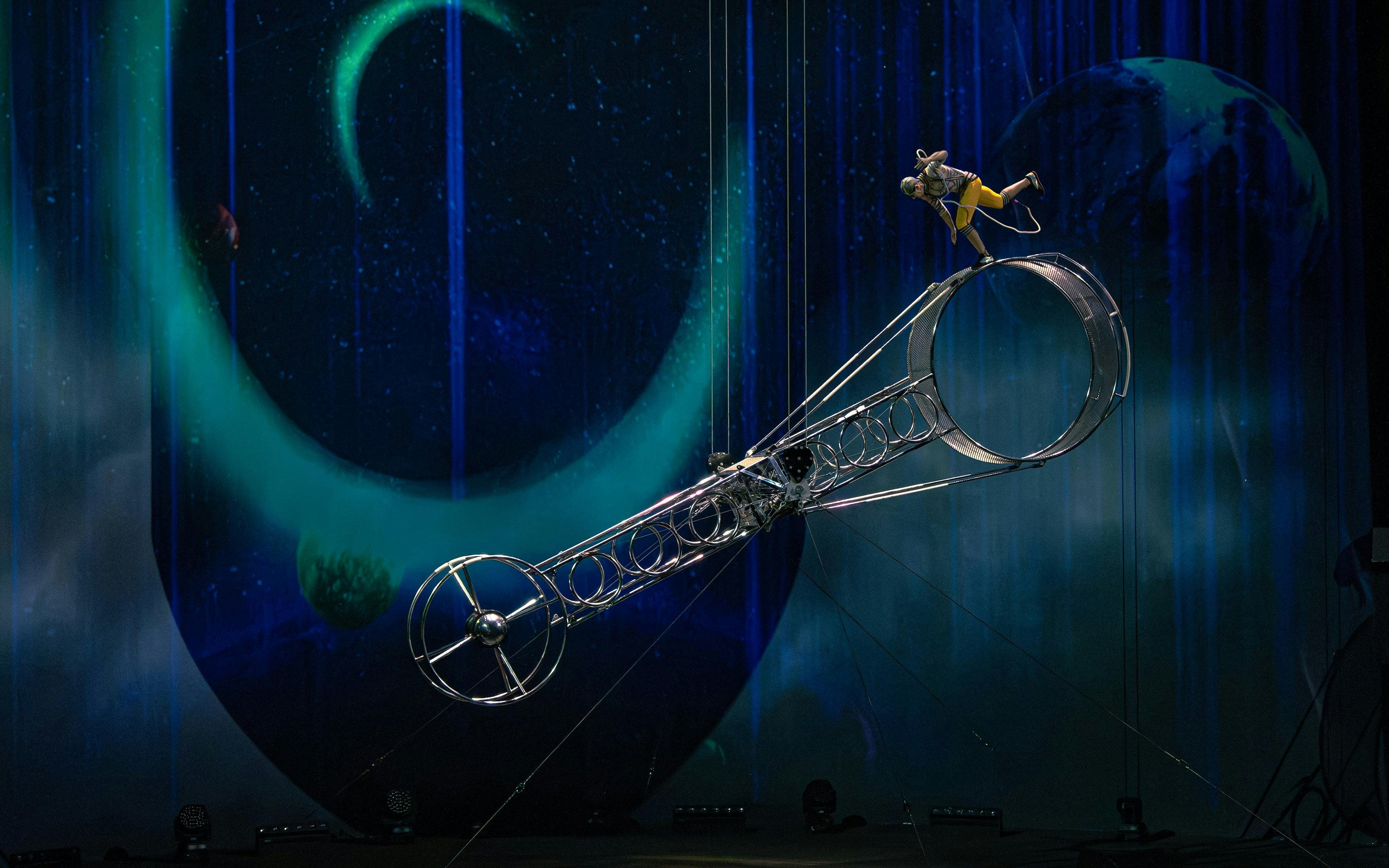 Performer balancing on Wheel of Life during La Perle show in Dubai.