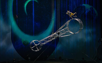 Performer balancing on Wheel of Life during La Perle show in Dubai.