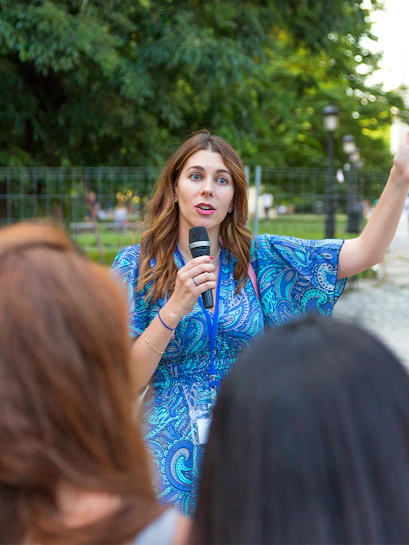 Tour guide speaking to group at Palace of Versailles.