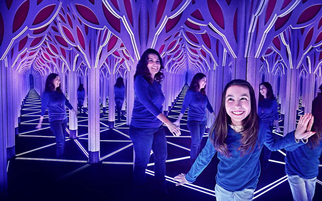 Visitors exploring a mirror maze in Chicago with the All-Inclusive City Pass.