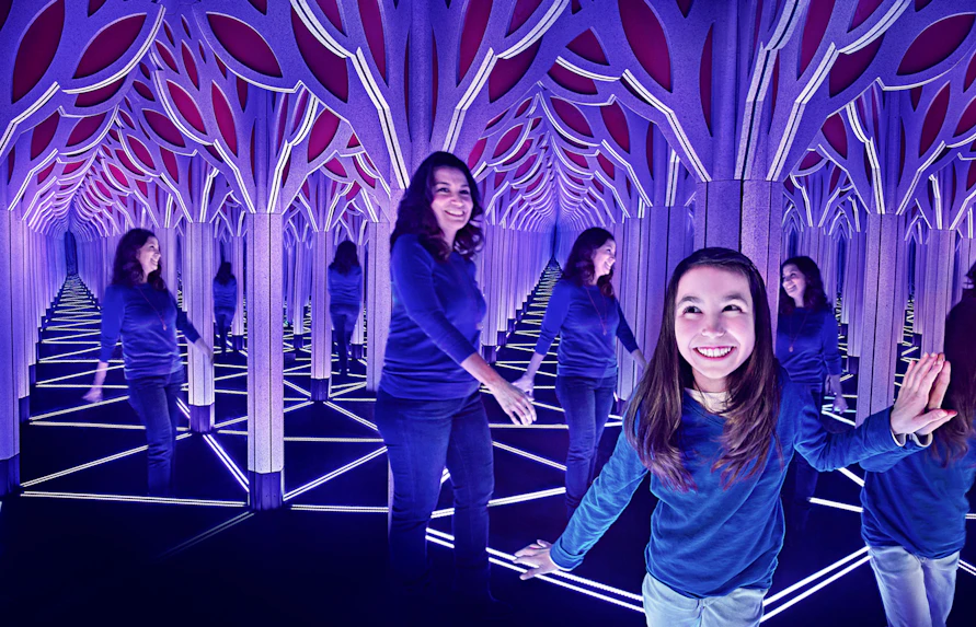 Visitors exploring a mirror maze in Chicago with the All-Inclusive City Pass.