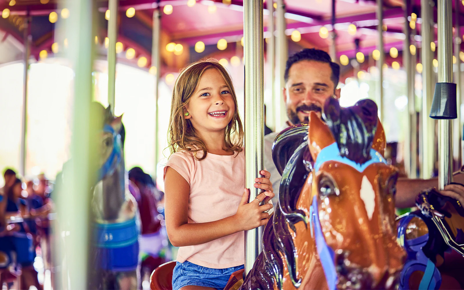 Child enjoying carousel ride at Canada's Wonderland, Six Flags.