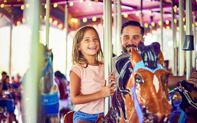 Child enjoying carousel ride at Canada's Wonderland, Six Flags.