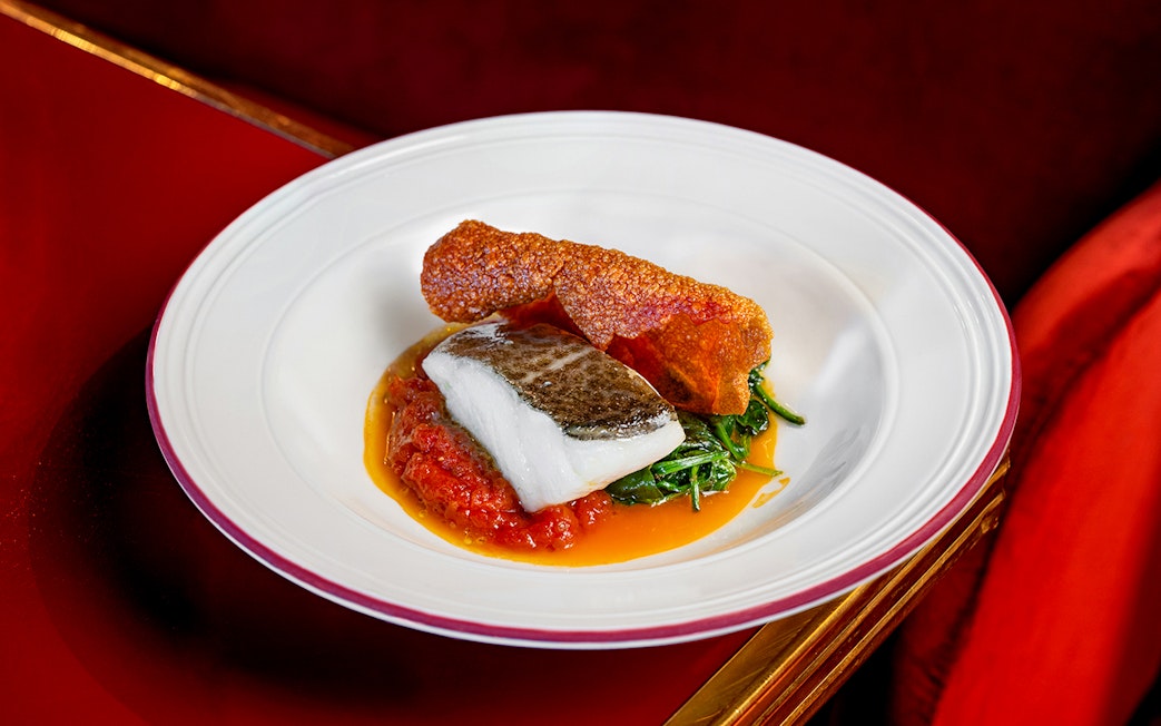 Grilled fish with crispy skin and vegetables served at Flamenco De Leones Show.