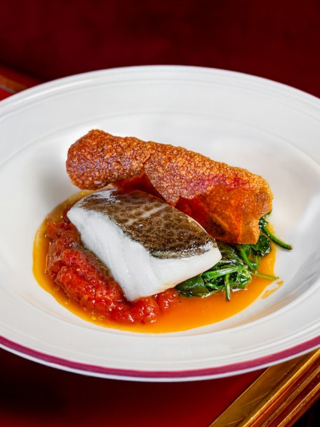 Grilled fish with crispy skin and vegetables served at Flamenco De Leones Show.