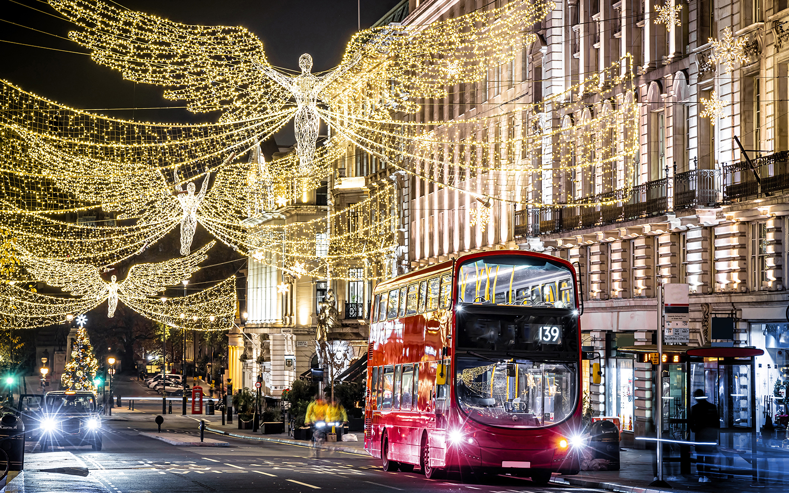 Christmas-themed double-decker bus tour in New York City with festive decorations.