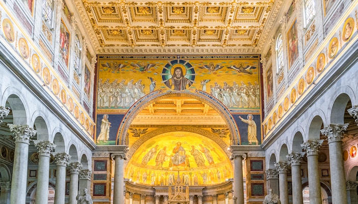 Interiors of the Basilica of Saint Paul outside the walls, Rome, featuring ornate mosaics and columns.